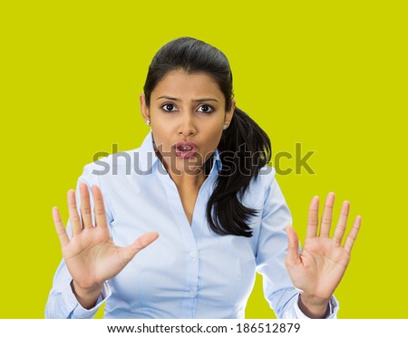 Closeup portrait, furious, mad, angry, annoyed, displeased young woman raising hands up to say no, stop right there, isolated green background. Negative human emotion facial expression sign symbol