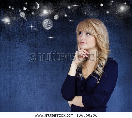 Closeup portrait young blonde woman dreaming, thinking about future, life on other planets, isolated gray-white space background with stars. Emotion, facial expression, feelings, attitude, perception
