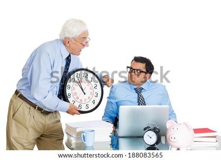 Closeup portrait, old business man boss, checking on young employee, pointing to clock, pushing to work hard on project, who is unhappy, isolated white background. Conflict at work place
