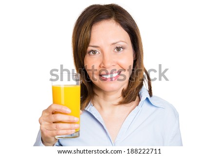 Closeup portrait young, happy, beautiful, smiling, healthy female holding glass orange juice isolated white background. Nutrition, organic diet weight loss program. Positive facial expression, emotion