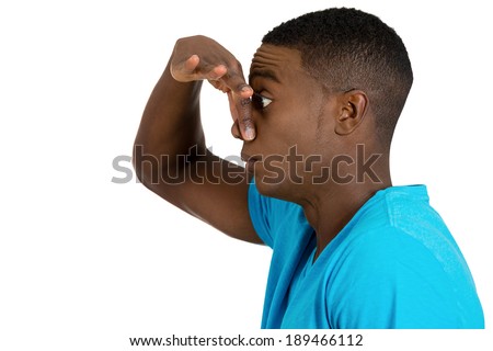 Closeup side view profile portrait, young man, disgust face, pinches his nose, something stinks, very bad smell, situation, isolated white background. Negative human emotion facial expression feeling