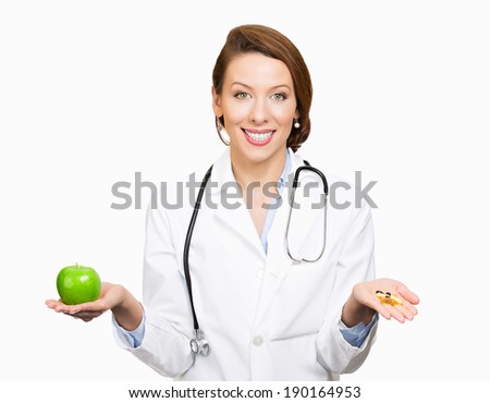Closeup portrait smiling, female health care professional, family doctor, endocrinologist,  nutritionist holding green apple, pills, vitamins. Diet modification, diabetes management, drugs alternative