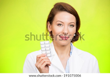 Closeup portrait smiling, health care professional, family doctor, endocrinologist, gynecologist, nutritionist, dentist holding, offering chewing gum, pills, vitamins. Female birth control methods
