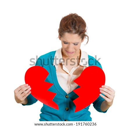 Closeup portrait young, troubled, sad, confused woman, holding broken heart in hands, crying, hysterical, isolated white background. Negative human emotion, facial expression, feelings, life reaction