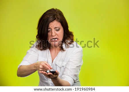 Closeup portrait middle aged, mad, frustrated angry woman yelling on phone isolated green background. Negative human emotion, facial expression, feeling, reaction Communication, conflict resolution