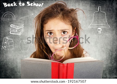 Closeup portrait sad, unhappy, stressed tired, overwhelmed funny looking little girl with messed up glasses, holding book isolated blackboard, back to school  Human facial expression, emotion, feeling
