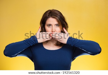 Closeup portrait young business woman covering closed mouth. Speak, no evil concept, isolated yellow background. Negative human emotions, facial expression, reaction, sign, symbols. Media news coverup