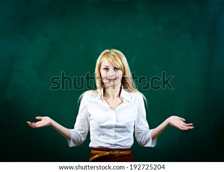 Closeup portrait confused, worried blonde young woman asking with hands, not sure which way, where to go in life, isolated green background. Emotion, facial expression, feeling, reaction, perception