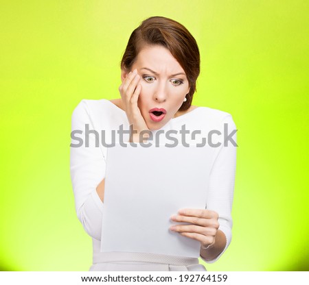 Closeup portrait shocked, funny looking young woman, disgusted at monthly statement, test, application, results isolated green background. Negative human emotion, facial expression, feeling. Bad news