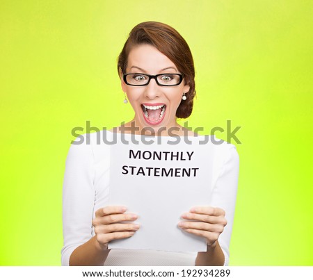 Closeup portrait happy excited young business woman looking at monthly statement glad to pay off bills, isolated green background. Positive emotions, facial expressions. Financial success, good news