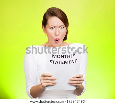Closeup portrait shocked, funny looking business woman, disgusted at monthly statement, can\'t believe her eyes, isolated green background. Negative human emotion, facial expression, feeling. Bad news