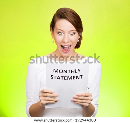 Closeup portrait happy excited young business woman looking at monthly statement glad to pay off bills, isolated green background. Positive emotions, facial expressions. Financial success, good news