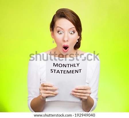 Closeup portrait shocked, funny looking business woman, disgusted at monthly statement, can\'t believe her eyes, isolated green background. Negative human emotion, facial expression, feeling. Bad news