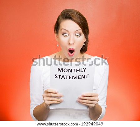 Closeup portrait shocked, funny looking business woman, disgusted at monthly statement, can\'t believe her eyes, isolated red background. Negative human emotion, facial expression, feeling. Bad news