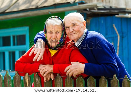 Closeup portrait happy, senior, elderly, old couple, grandmother, grandfather, pensioners on porch of country house, waiting, looking for kids. Human emotions, facial expressions, life perception