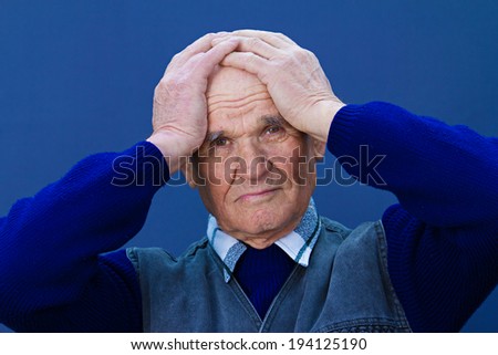 Closeup portrait, headshot senior, worried mature elderly man, old sad guy, grandfather, troubled, isolated blue background. Human emotions, facial expressions, life perception, aging, depression