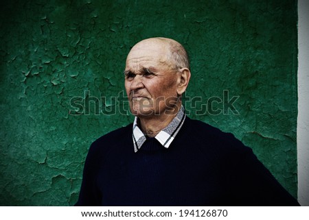 Closeup portrait, headshot senior, mature, elderly man, old sad guy, troubled, deep thought isolated green background. Human emotion, facial expressions, life perception, aging, depression, loneliness