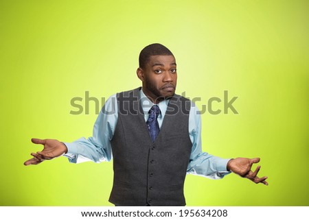 Closeup portrait dumb looking, clueless business man, arms out asking why, what\'s problem, so what, I don\'t know, isolated green background. Negative human emotion facial expression, life perception