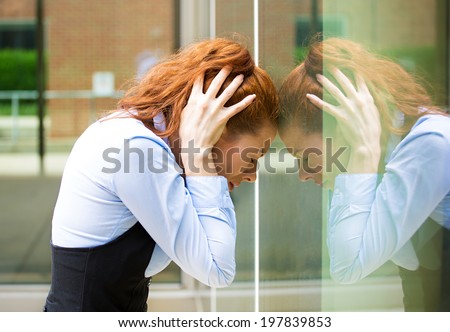 Closeup portrait unhappy sad young business woman head on window bothered by mistake having bad headache isolated background corporate office. Negative human emotion facial expression feeling reaction