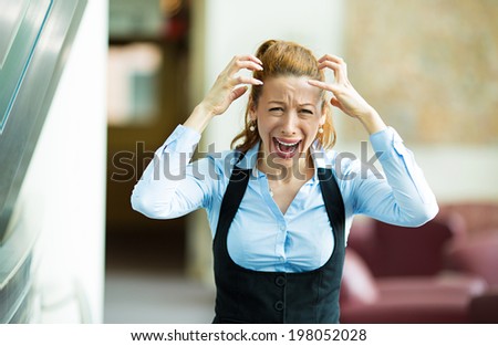 Closeup portrait mad, angry, upset stressed young businesswoman, worker, furious yelling hands in air, isolated background corporate office. Negative human emotions, facial expression, reaction
