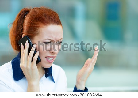 Closeup portrait upset sad, skeptical, unhappy, serious woman talking on phone, walking in hallway isolated office background. Negative human emotion facial expression feeling, life reaction. Bad news