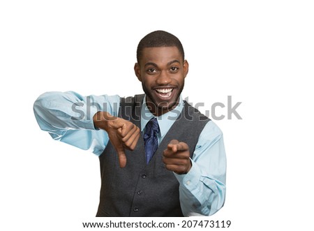 Closeup portrait sarcastic young man showing one thumbs down sign hand gesture, happy that someone made mistake, lost, failed isolated white background. Negative emotions, facial expressions, feelings