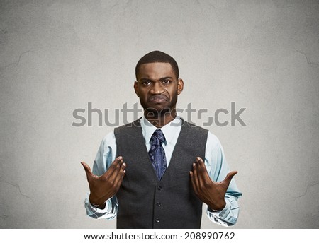 Closeup portrait surprised, angry, mad, unhappy, annoyed young executive man, asking question: you talking to, mean me? Isolated grey color wall background. Negative human emotion, facial expression