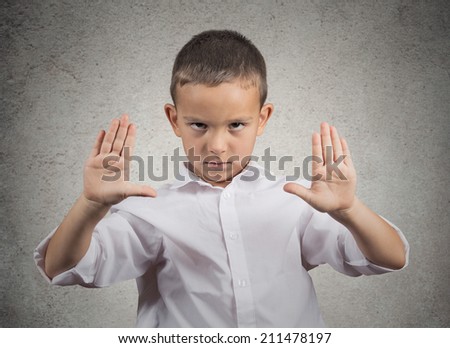 Closeup portrait angry, annoyed, displeased young man raising hands up to say no stop right there isolated grey wall background. Negative human emotion, facial expression, sign, gesture, body language