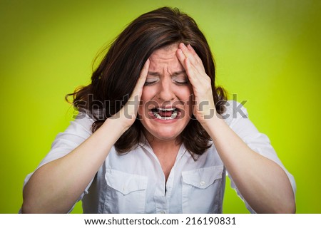 Closeup portrait stressed business woman having breakdown hysterical yelling screaming with temper tantrum isolated green background. Negative human emotions facial expressions reaction attitude