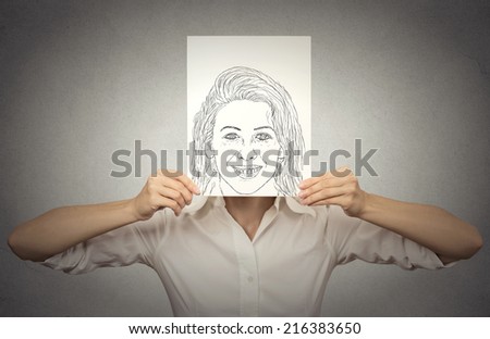 beautiful woman with happy self portrait in front of her face, hiding her true emotions, mood, isolated on grey wall background. Private life, identity concept. faceless personality