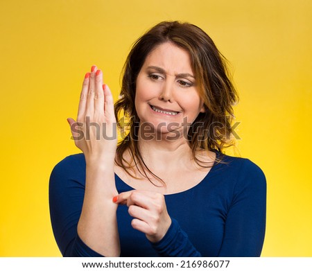 Reality check gesture. Portrait surprised woman pinching her arm skin, is this dream, for real, did it happen isolated yellow background. Human emotion, expression, feeling body language, perception