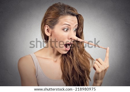 Woman with long nose isolated on grey wall background. Liar concept. Human face expressions, emotions, feelings.