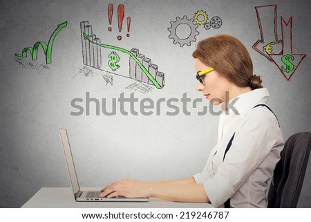 Business woman with glasses working on computer, anticipation of financial crisis, bad, poor economy, grey wall background. Corporate employee thinking, making decisions. Face expressions