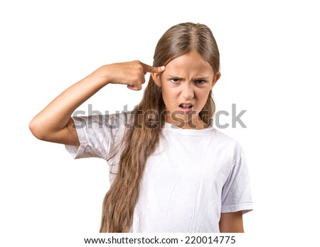 Closeup portrait angry mad teenager girl gesturing with her finger against temple asking are you crazy? Isolated white background. Negative human emotions facial expression feeling body language