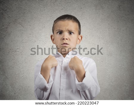 Closeup portrait surprised child boy getting unexpected attention from people asking you talking to, mean me? pointing fingers at himself isolated grey wall background. Human facial expression emotion