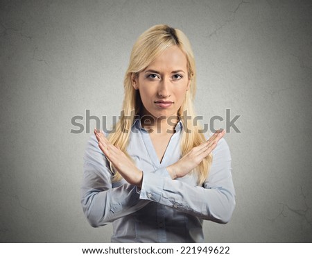 Closeup portrait angry young woman with X gesture to stop talking, cut it out, dont go there, isolated grey wall background. Negative emotion facial expression feeling sign symbols, body language