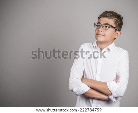 Portrait happy confident teenager thinking daydreaming looking up isolated grey wall background with copy space. Human face expressions, emotions, feelings, body language, perception