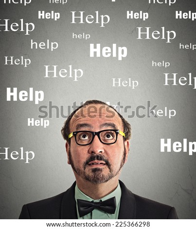 man needs help. Headshot middle aged business man with glasses looking up thinking help words above head isolated grey wall background. Human face expression emotion life perception