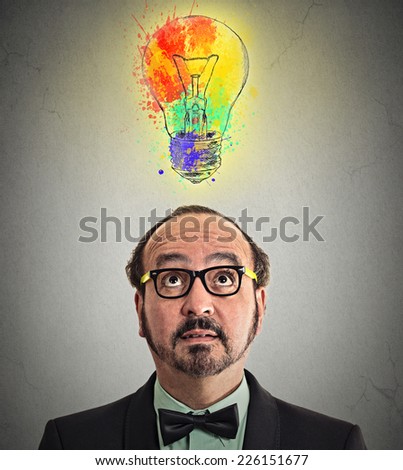 headshot man having brilliant idea colorful lightbulb above head isolated grey wall background. Human face expression emotion perception. Creativity imagination dynamism intelligence iq concept