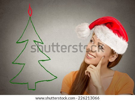 x-mas, winter, happiness concept smiling woman in santa helper hat looking at christmas tree. Positive emotion perception vision