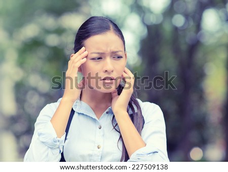 Stress. Closeup portrait unhappy business woman hands on head bothered by mistake having bad headache isolated outside outdoors background with park trees. Negative human emotion facial expression