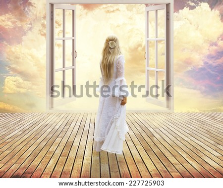 beautiful girl in white dress standing looking into open window dreamland day light surreal sky skyline view. Positive human emotion feeling happiness life perception success peace of mind concept