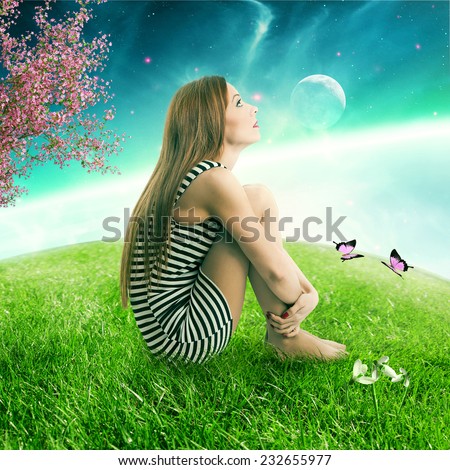 Thoughtful young woman sitting on on a green meadow earth planet looking up at starry sky with moonlight. Ecology eco friendly world concept. Dreamland outdoors relaxation environment  screen saver