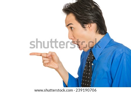 Closeup side view profile portrait headshot young shocked man pointing index finger at something stunned looking at someone gesture isolated white background. Human emotion facial expression reaction