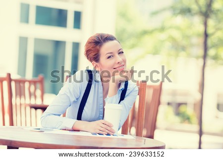 Portrait happy woman drinking coffee in sun sitting outdoor in sunshine light enjoying her morning cup of tea. Smiling businesswoman model in her 20s outside. Positive face expression, emotion feeling