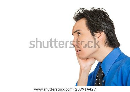 Worried stressed. Closeup side view portrait man, young corporate executive, worker, businessman, daydreaming, thinking looking upwards isolated on white background. Human emotions, face expression