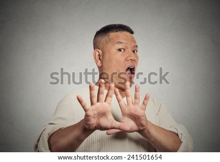 Closeup portrait middle aged  man looking shocked scared trying to protect himself from unpleasant situation dodge isolated grey wall background. Negative emotion face expression feeling reaction