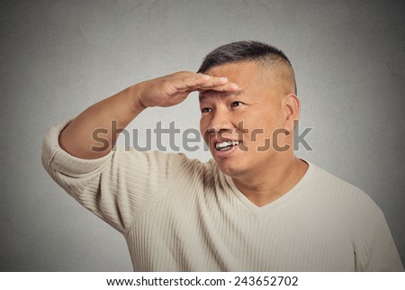 Headshot happy middle aged man searching looking far away into future monitoring isolated grey background. Human face expression emotion body language. Curiosity  forecast vision perception concept
