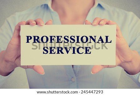 Closeup businesswoman hands holding Professional service sign card towards you, vintage retro filter effect toned image