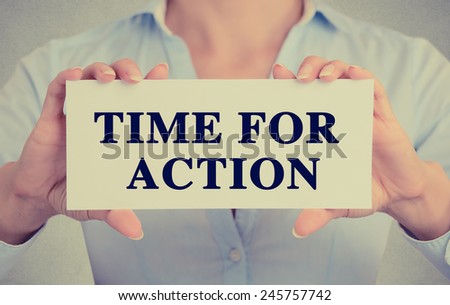 Closeup businesswoman hands holding white card sign with time for action text message isolated on grey wall office background. Retro instagram style image. Proactive life concept